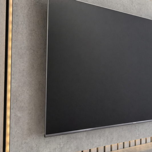 Modern wall-mounted television with concrete-like frame and gold accent