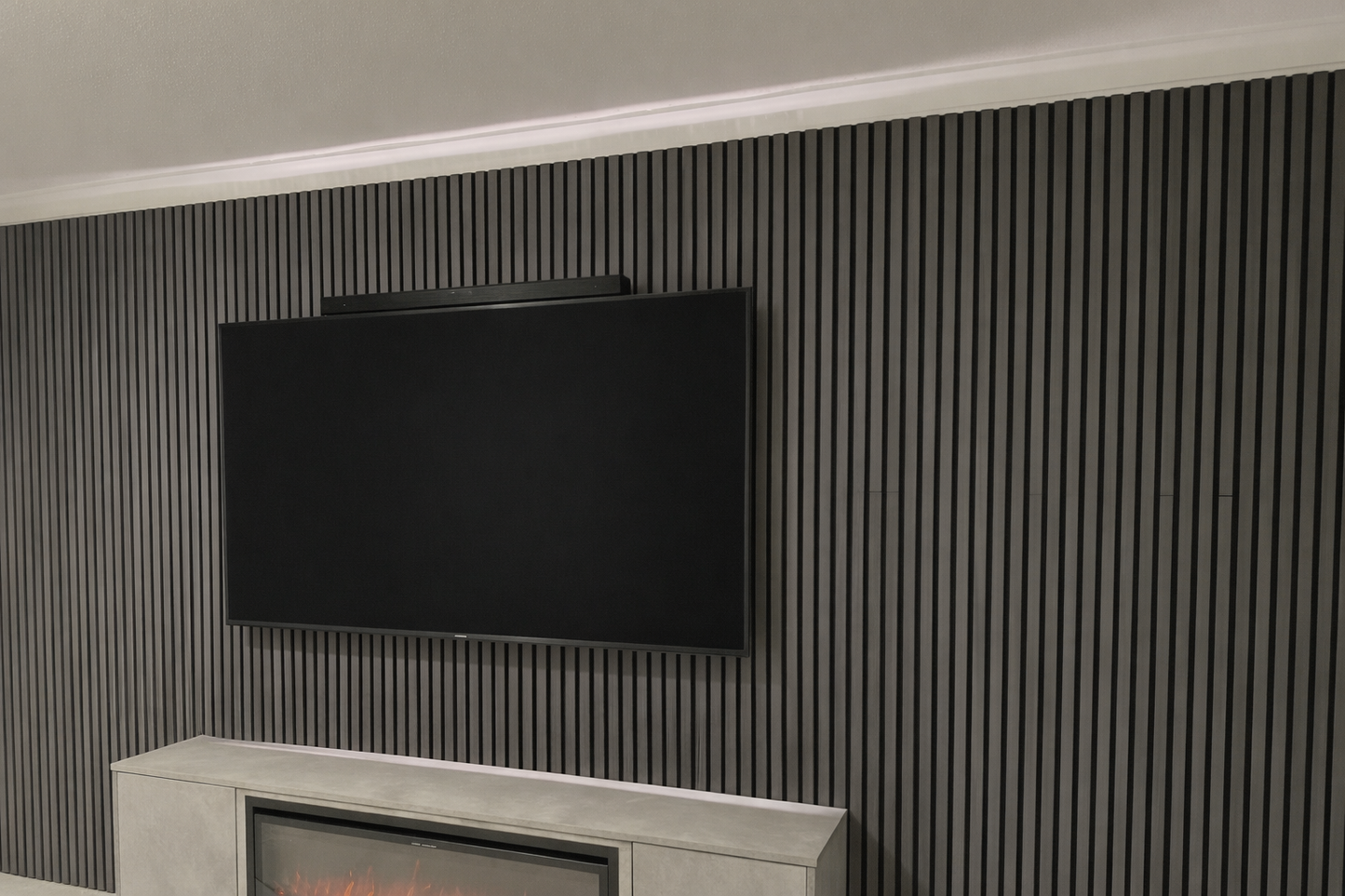 TV mounted on a wall with acoustic panels above a fireplace